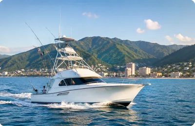 A sportfishing boat running past the Puerto Vallarta shoreline and the Sierra Madre